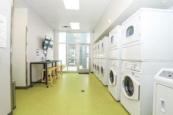 A laundry room with washers and dryers.